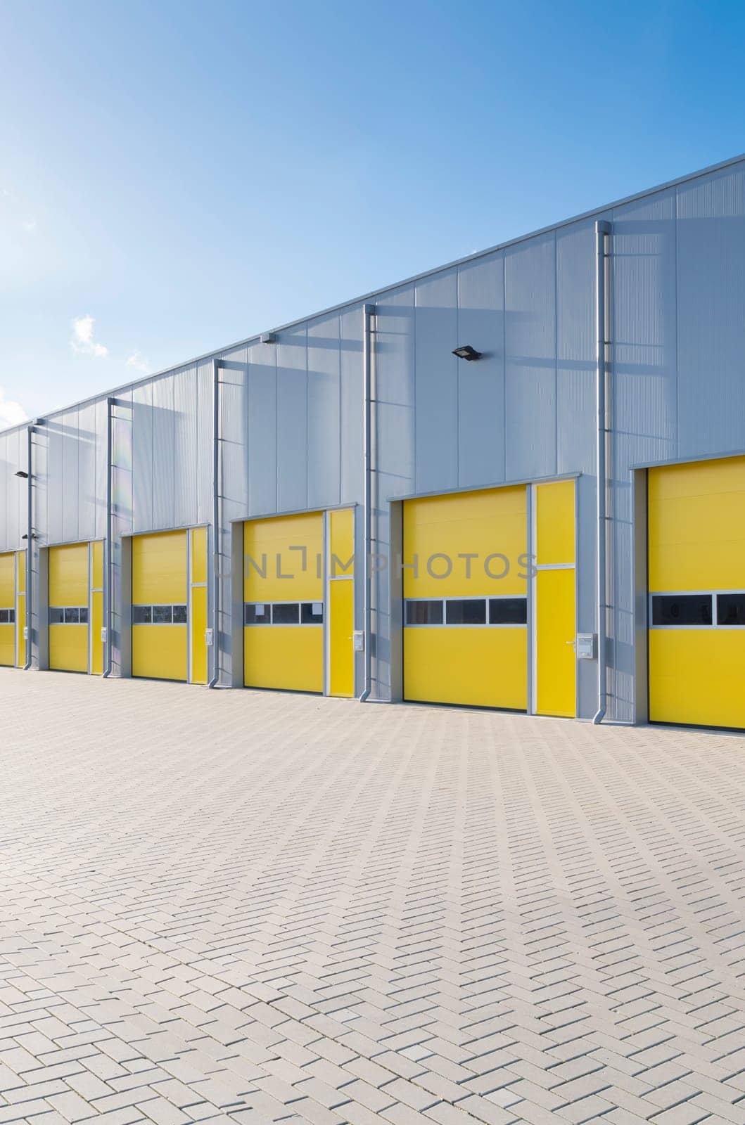 exterior of a commercial warehouse with yellow roller doors