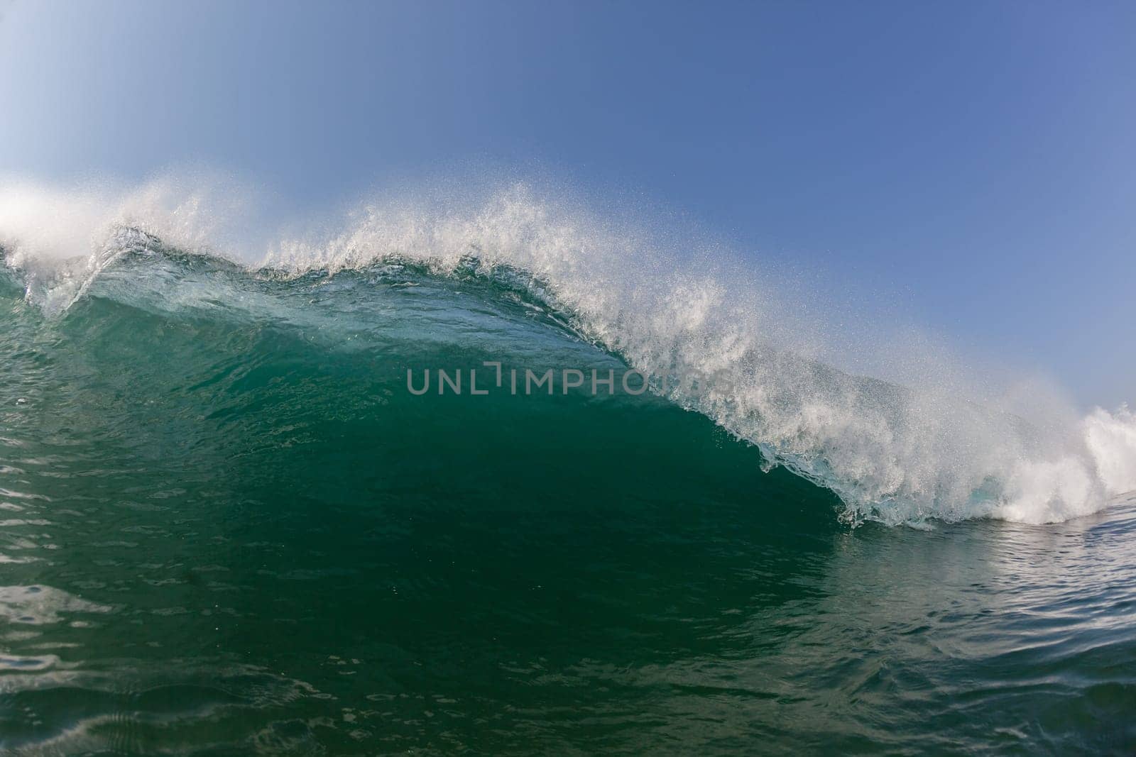 Ocean wave lip water crashing towards shallows with power energy of nature