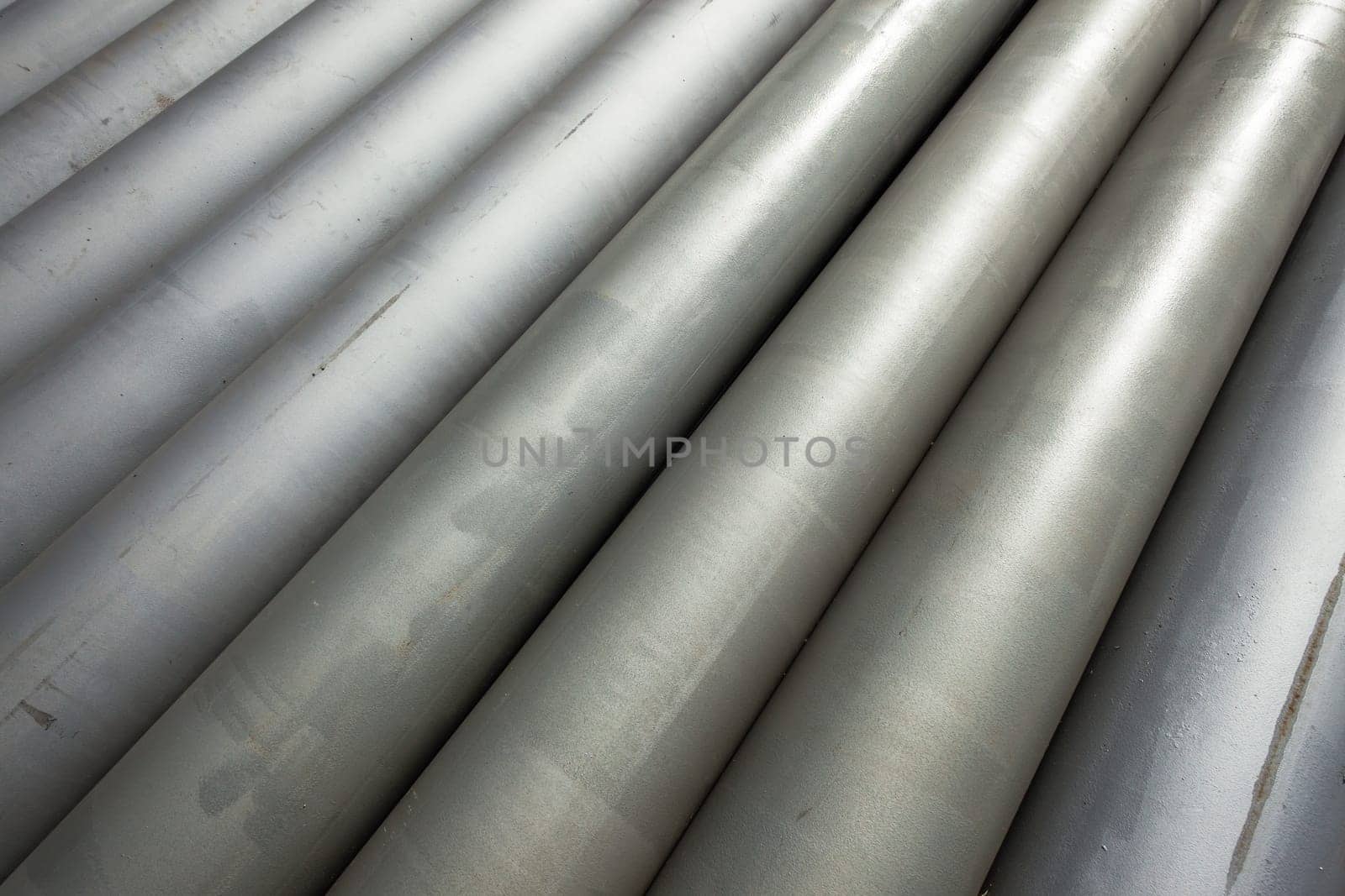 Pipes steel for  water liquid construction stacked together in diagonal closeup photo