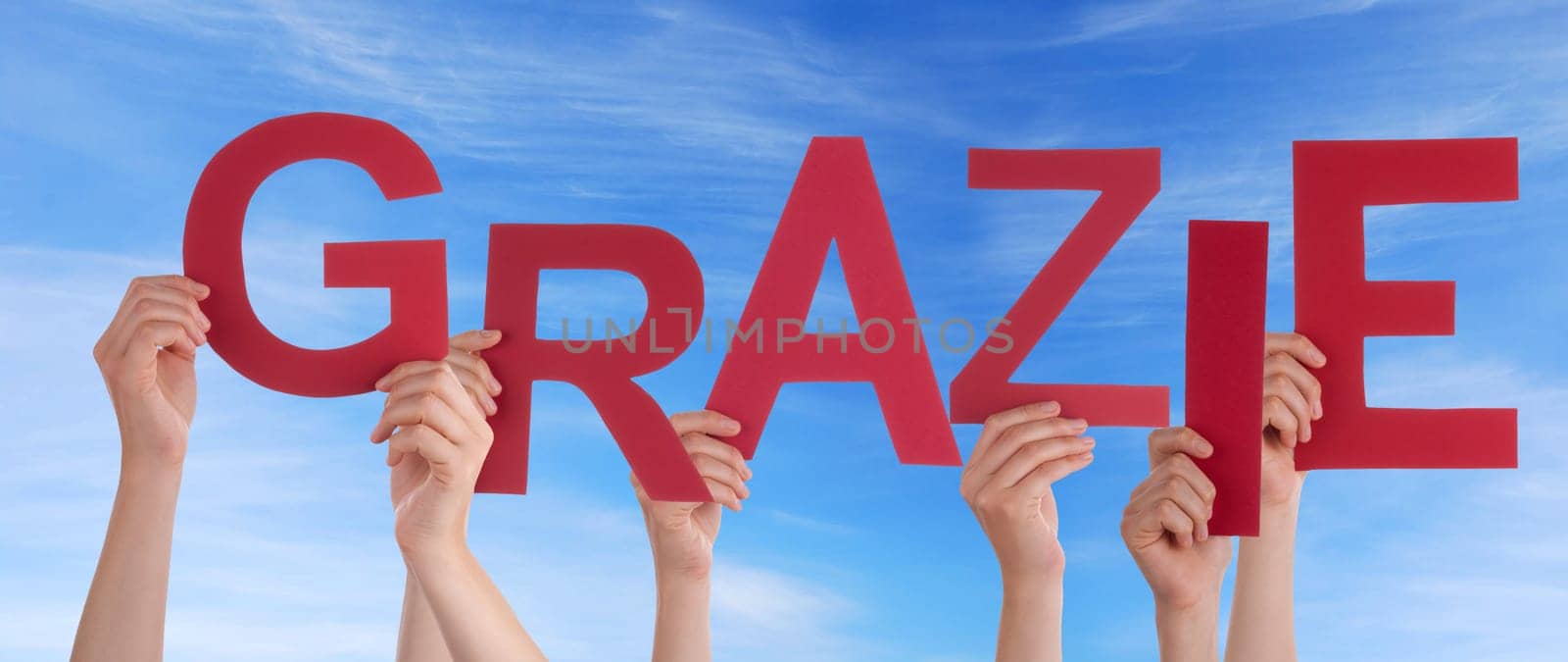 hands holding four pieces of a puzzle with copy space, gray background