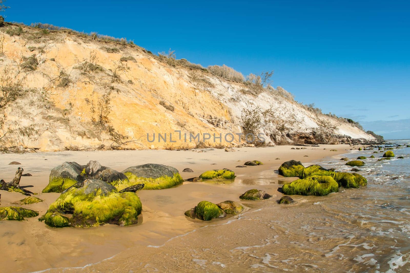 Rainbow beach color sands and rocks alongside ocean sea embankment