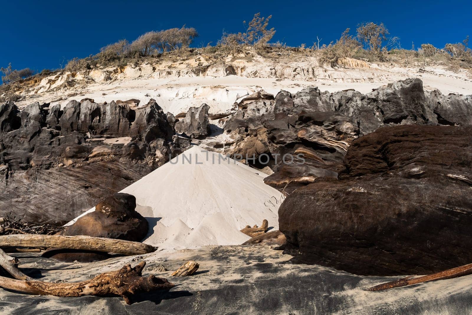 Rainbow beach color sands and rocks alongside ocean sea embankment