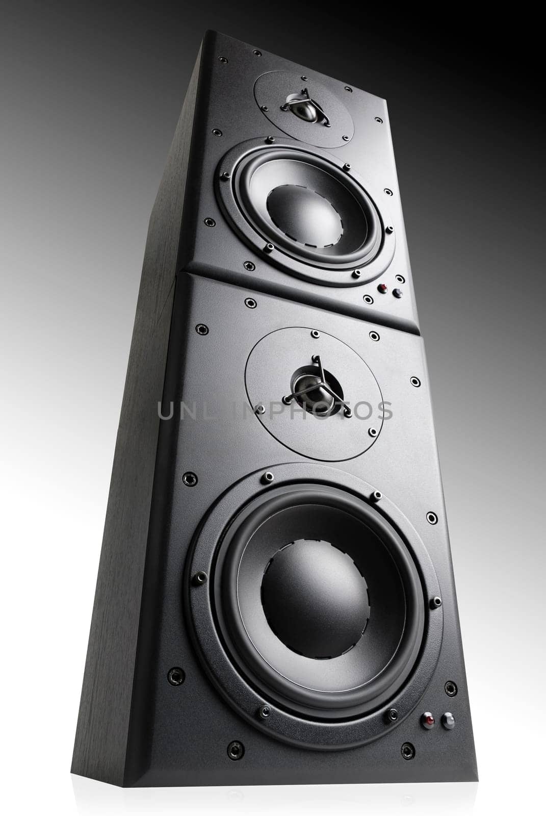 Black hi-fi boxes standing on top of each other,on a grey background