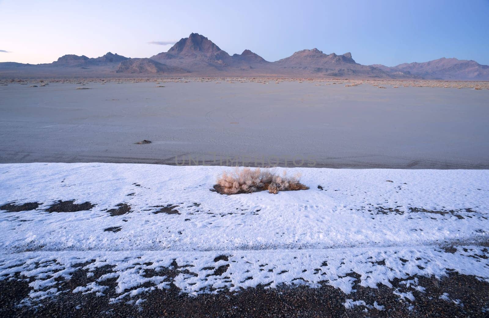 The salt melts the snow first on the flats at sunset