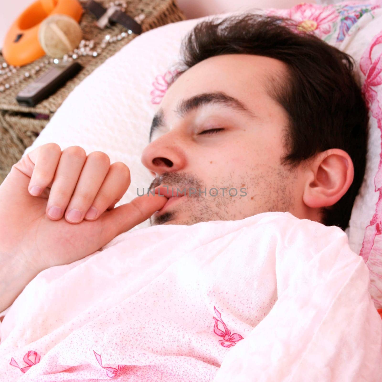 Young man sleeping in bed .