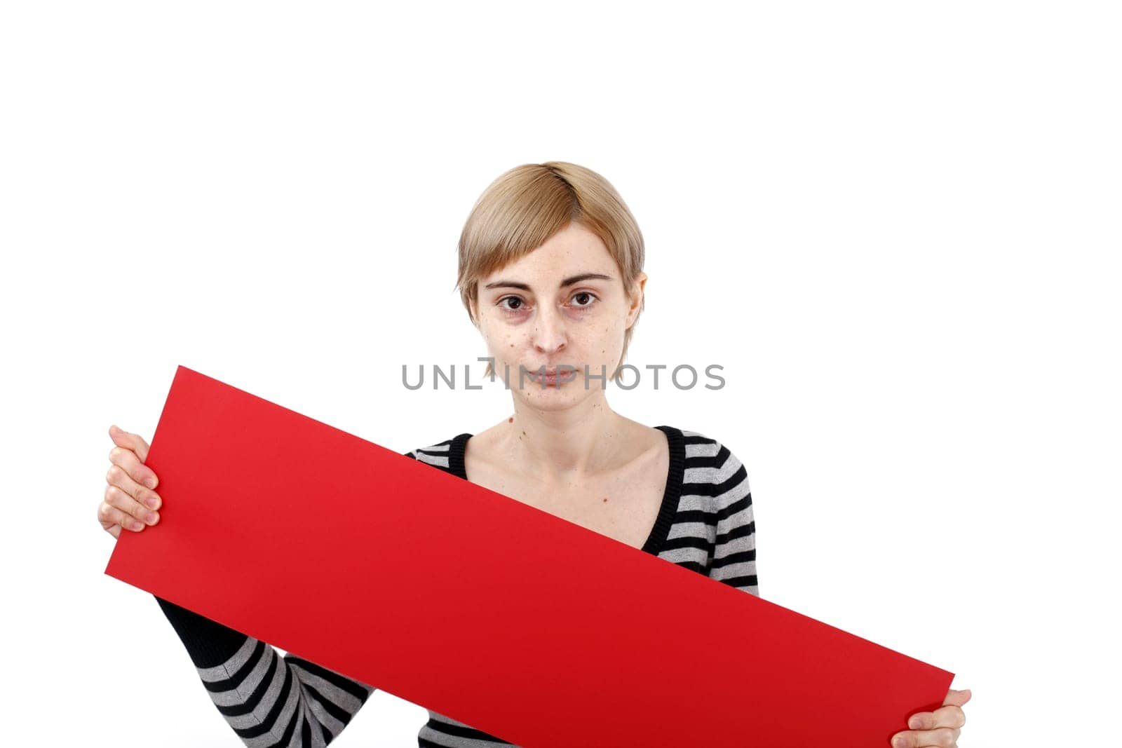 Young blonde woman holding a blank piece of paper.