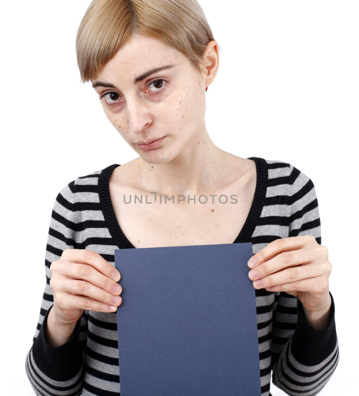 Young blonde woman holding a blank piece of paper.