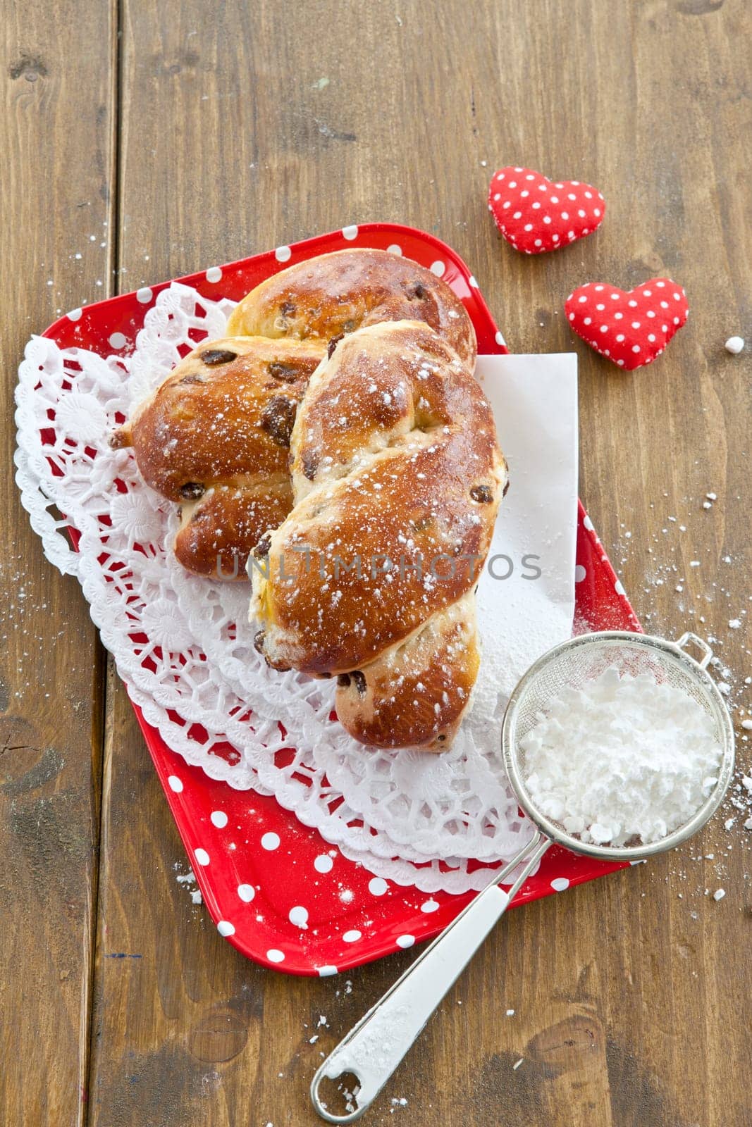 Homemade broetches with raisins on small red tray