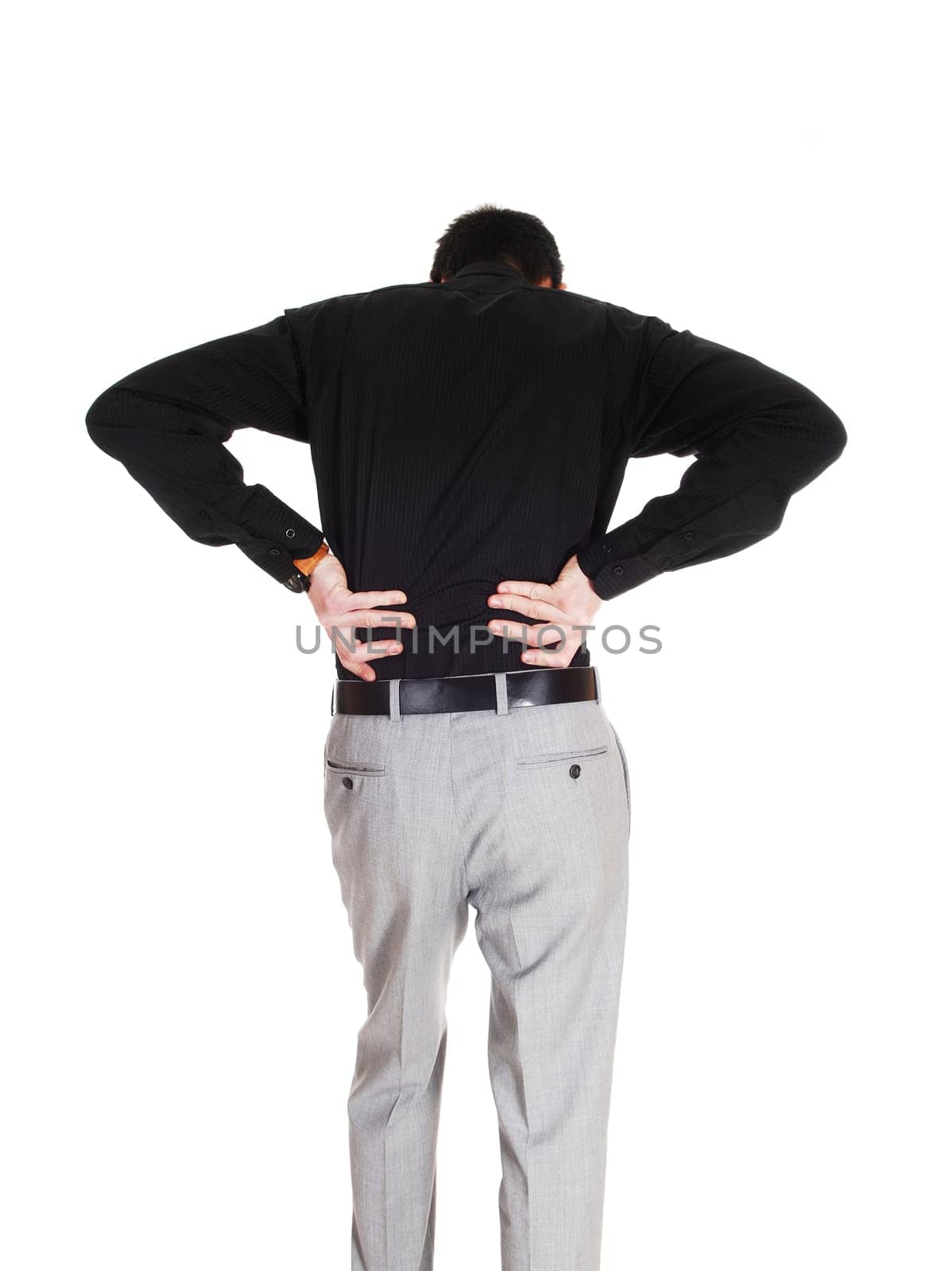 A young businessman standing from the back holding his hands on.his back for heavy back pain, isolated for white background..