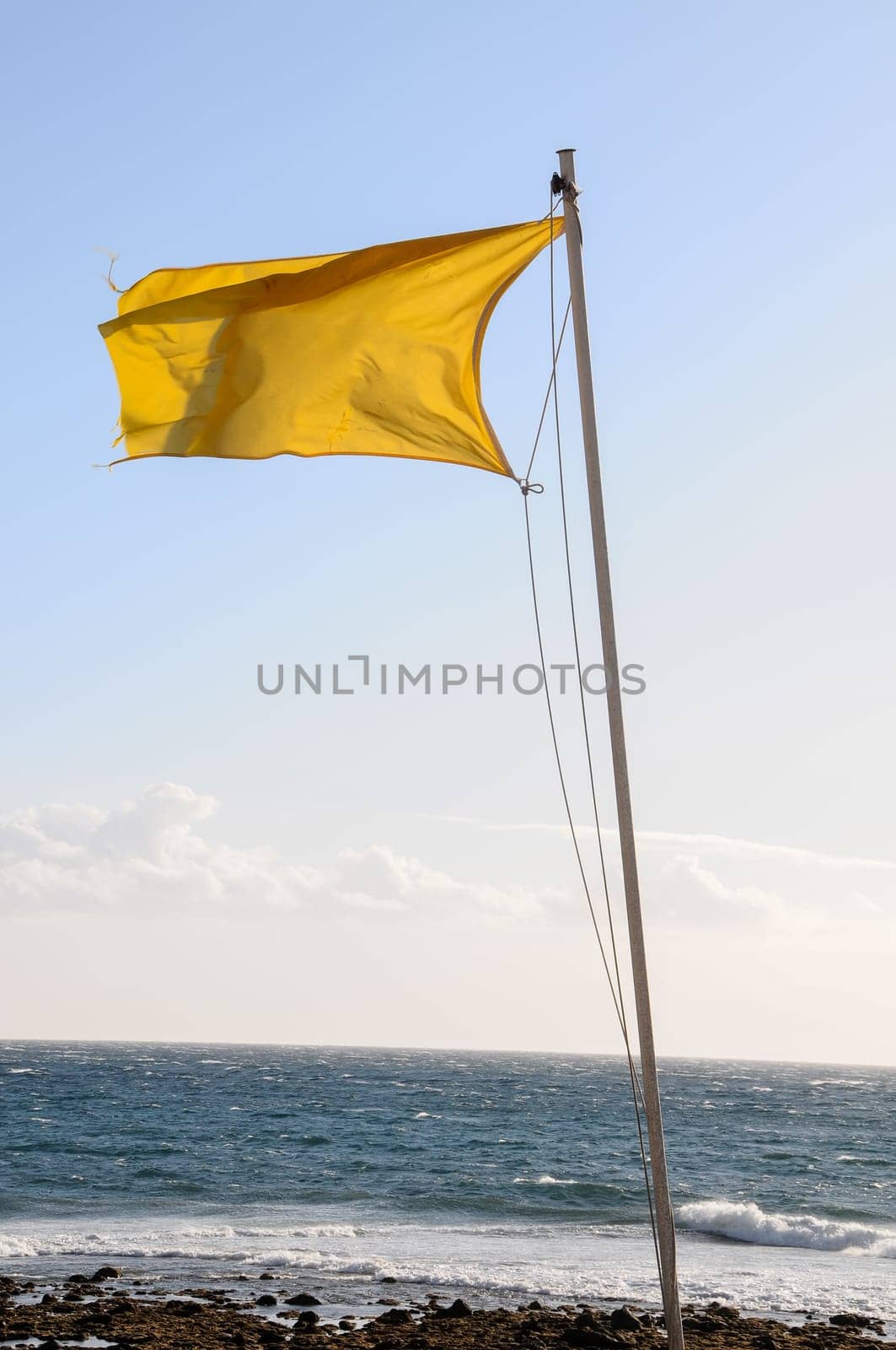 Yellow Festive Flag Waving In The Wind Tenerife Canry Island Spain