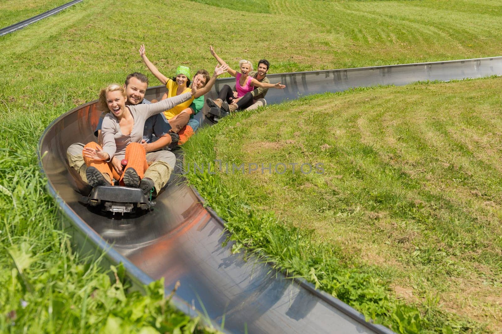 Portrait of happy young couples enjoying summer sledge ride