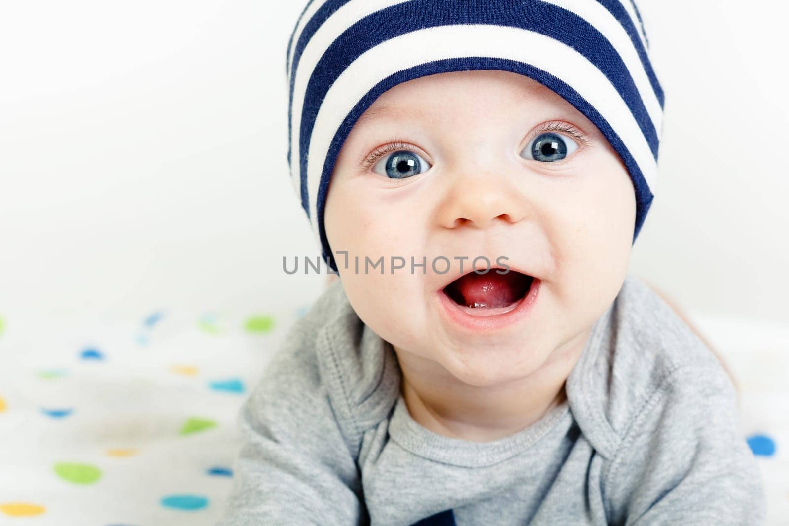 Funny cute blue-eyed baby. Little happy boy