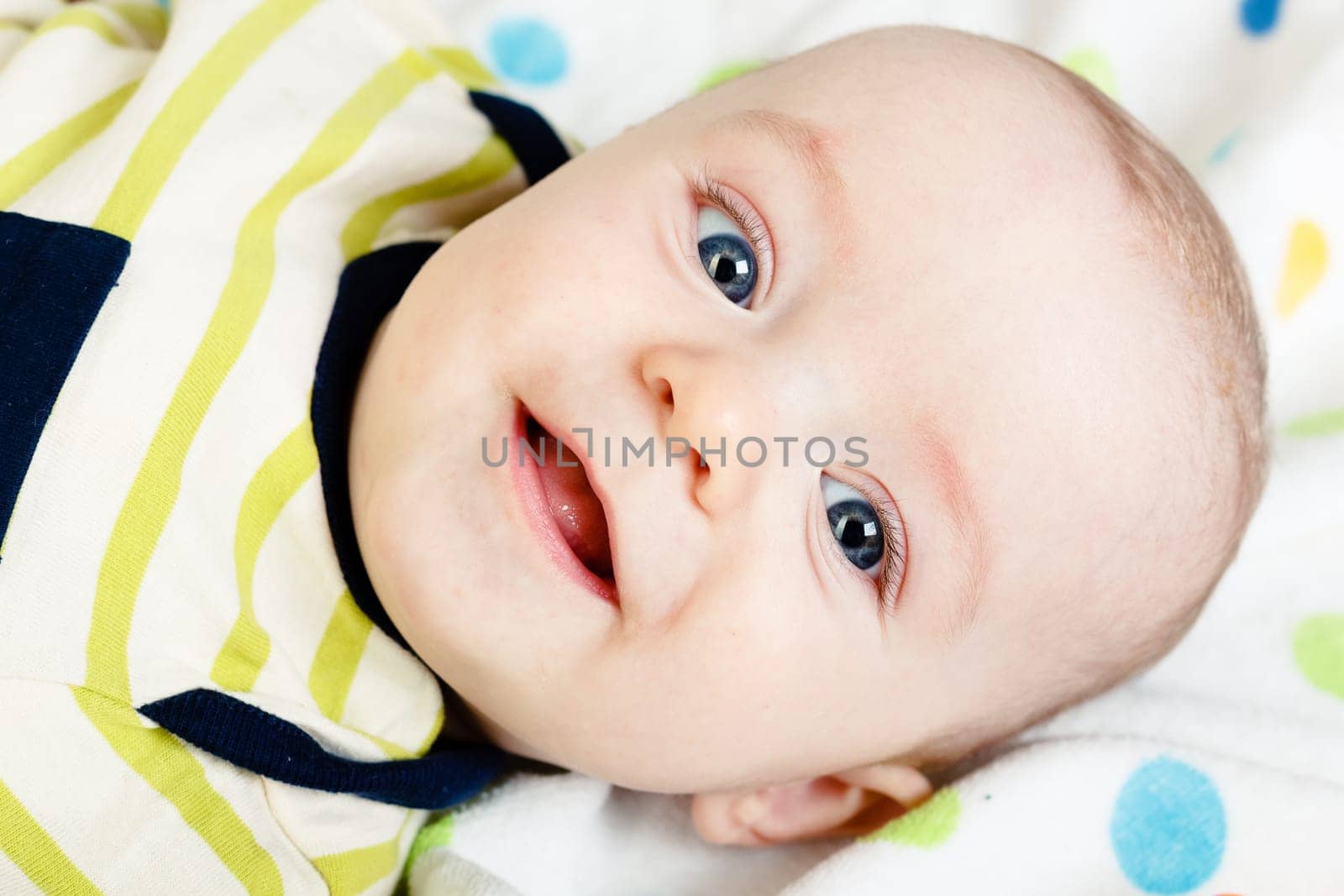 Funny cute blue-eyed baby. Little happy boy