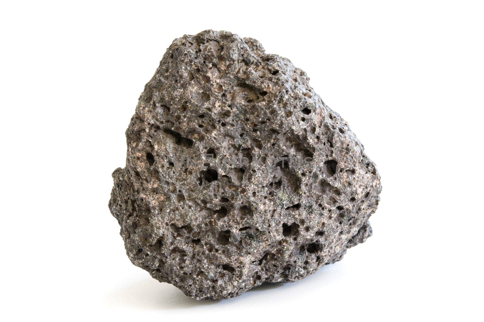 Piece of volcanic extrusive igneous rock with abrasive porous surface isolated on white