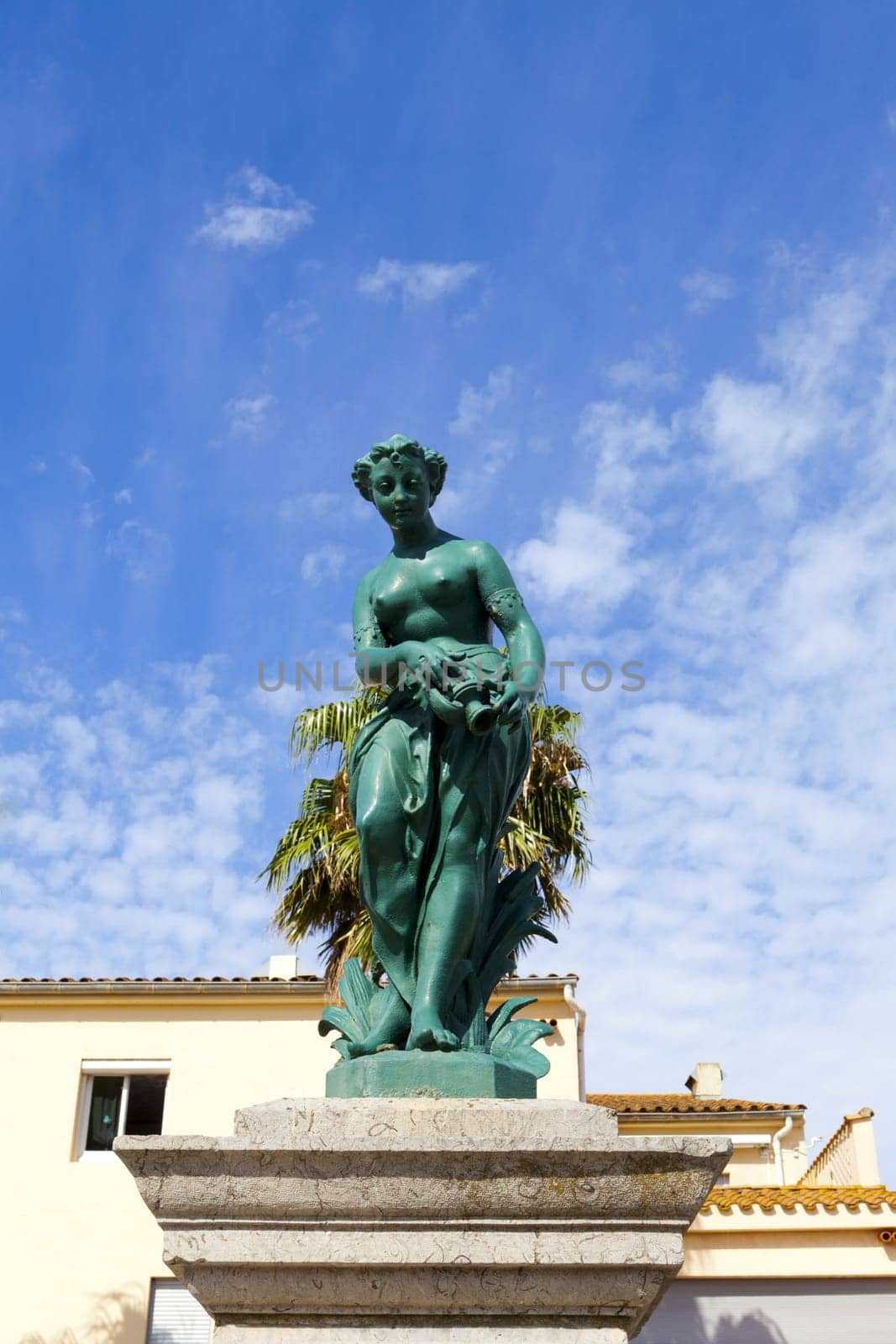 Fountain sculpture in front of a bright blue sky