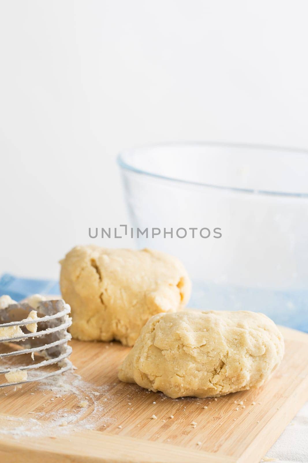 Two balls of cookie dough on cutting board with copy space at top.