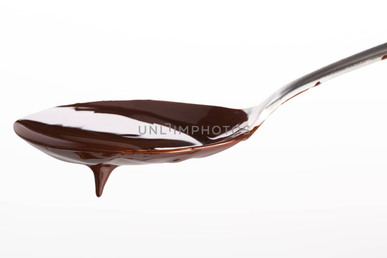 Spoon of melted chocolate topping on white background