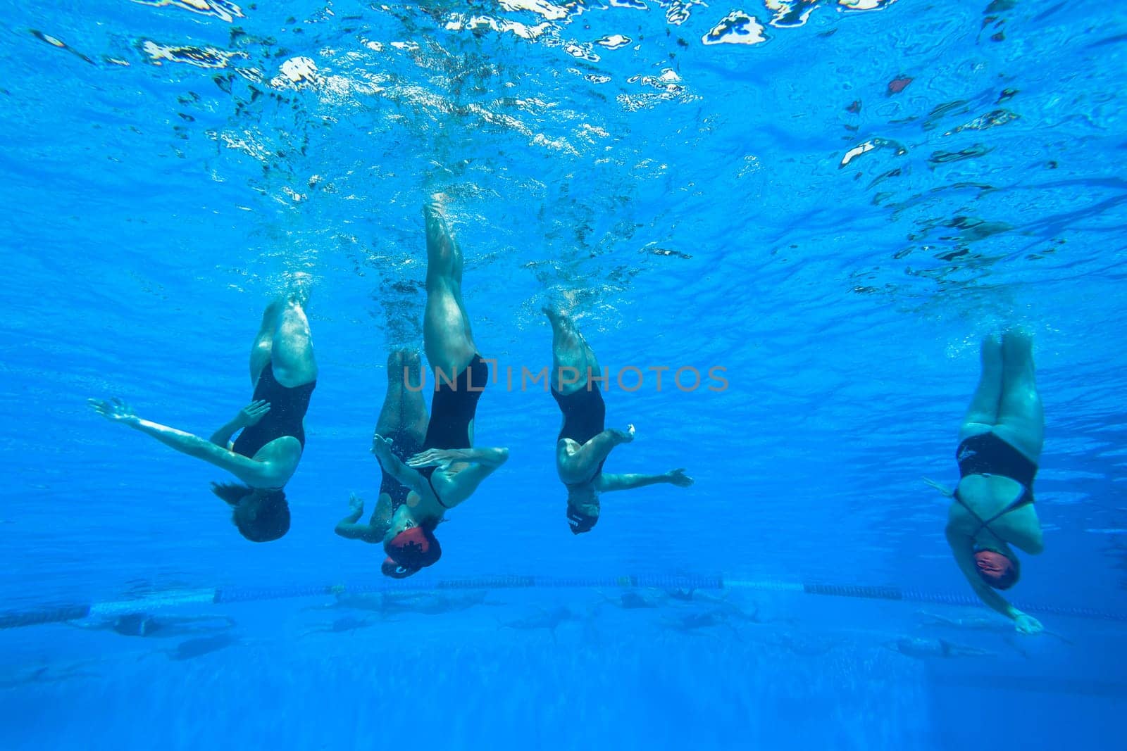 Girls Synchronized underwater swimming water action at national championships