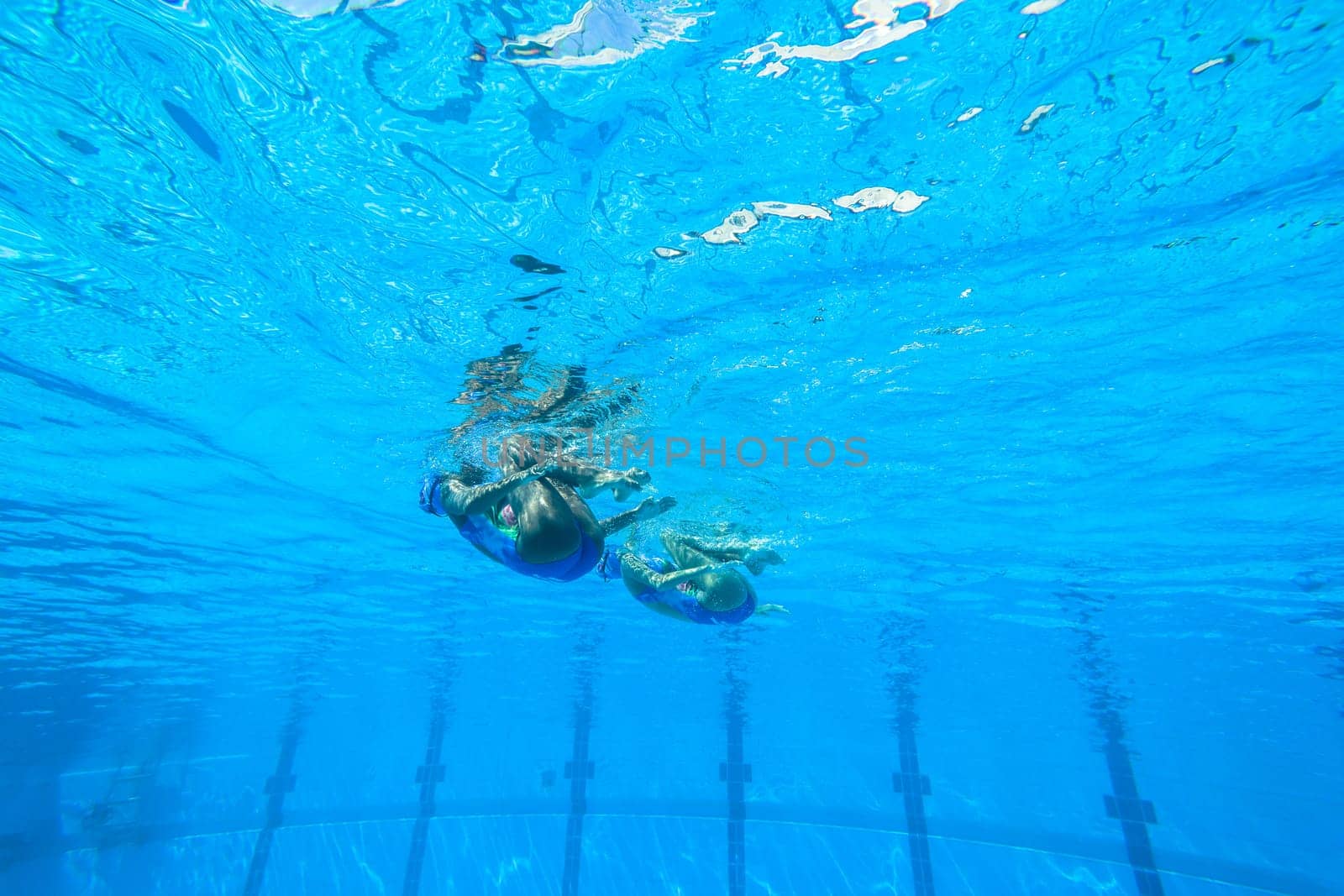 Girls Synchronized underwater swimming water action at national championships