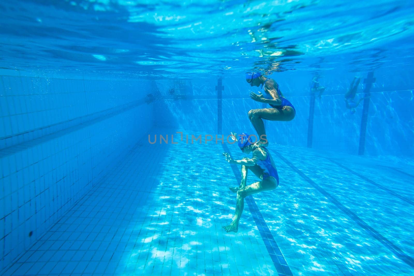 Girls Synchronized underwater swimming water action at national championships