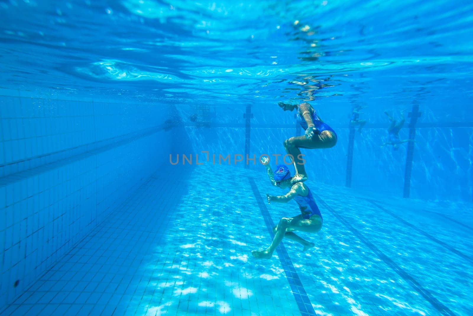 Girls Synchronized underwater swimming water action at national championships