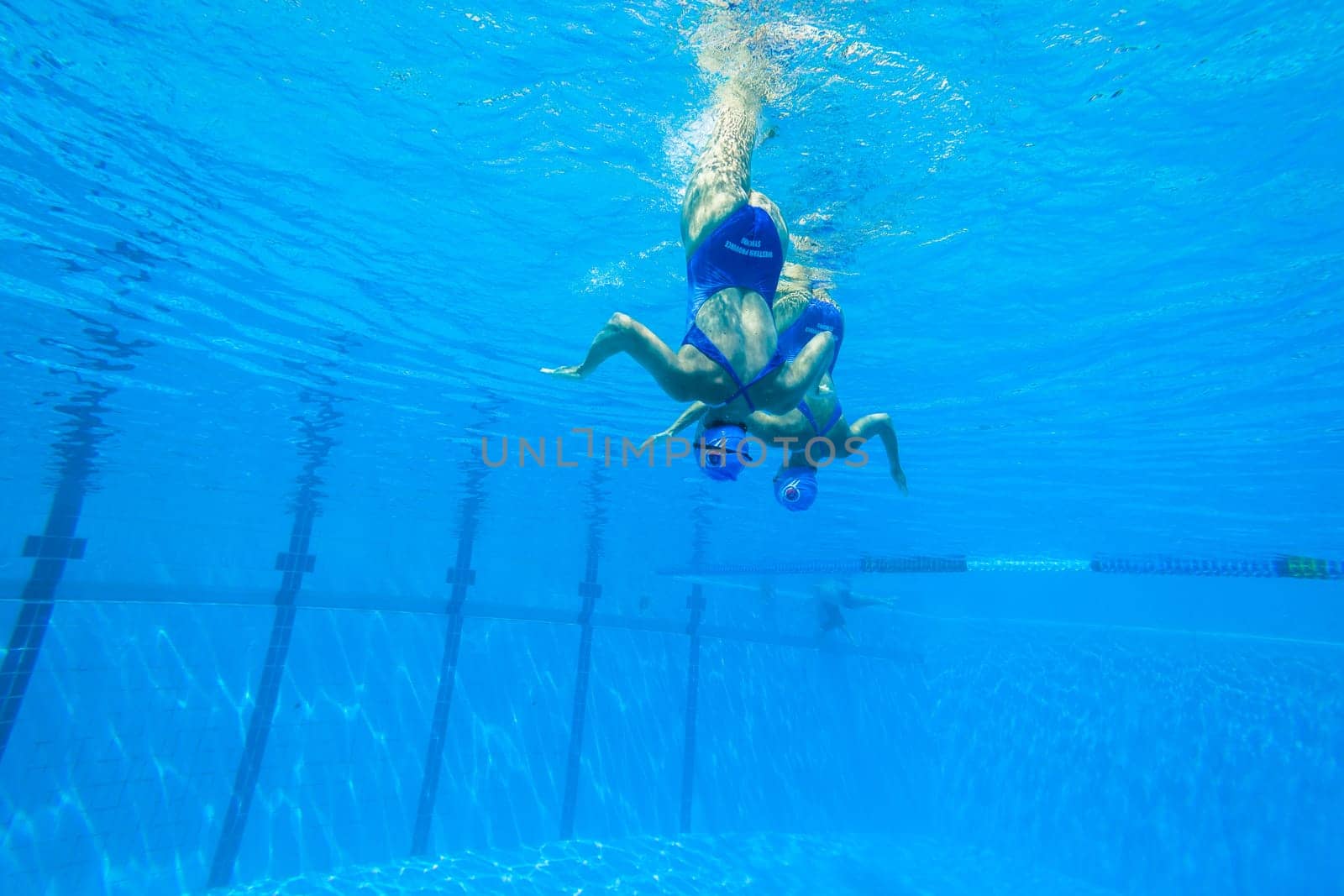 Girls Synchronized underwater swimming water action at national championships