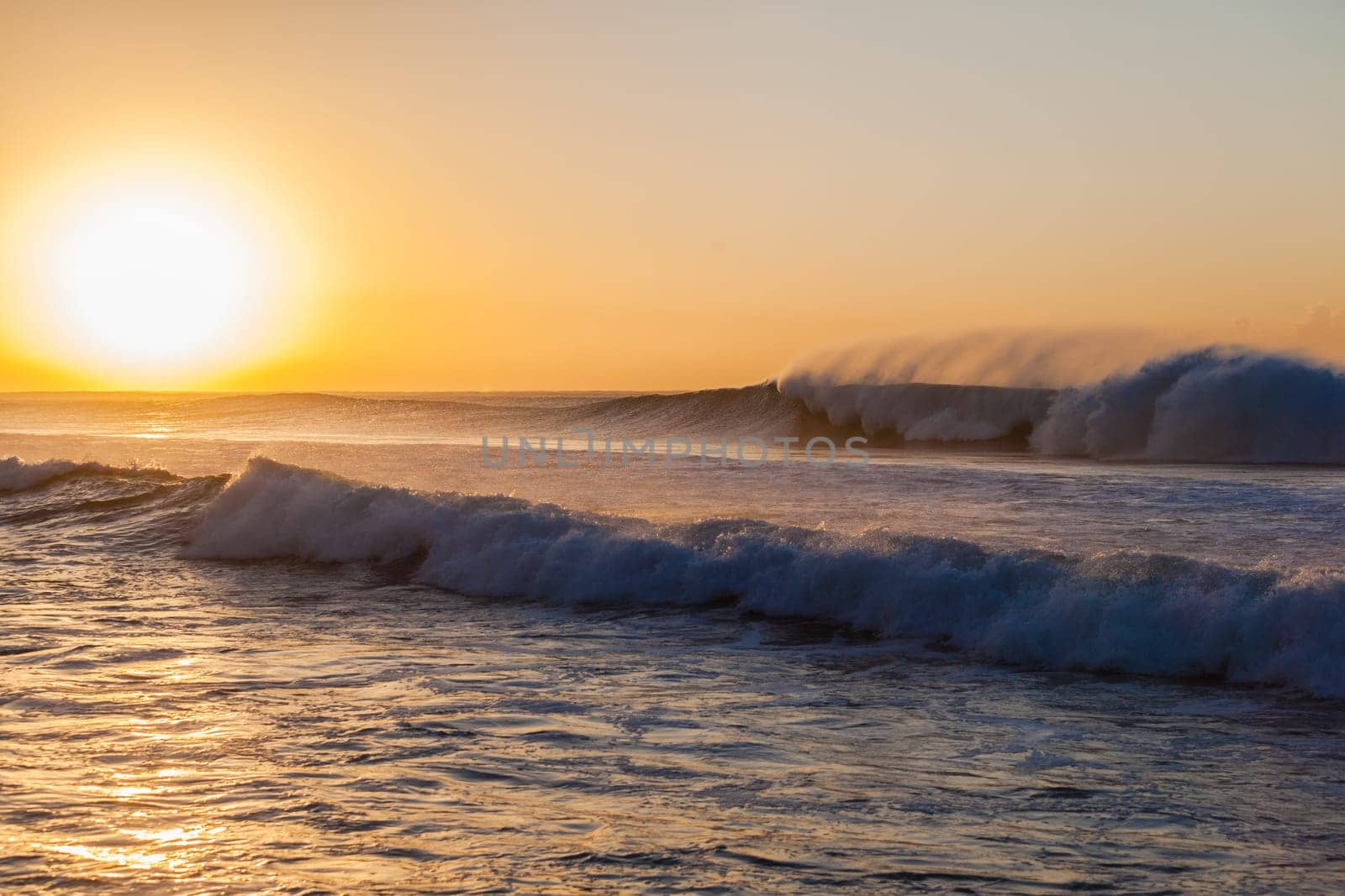 Ocean waves crashing breaking on shallow reefs and washing along beach coastline into concrete tidal pool with power and energy of nature