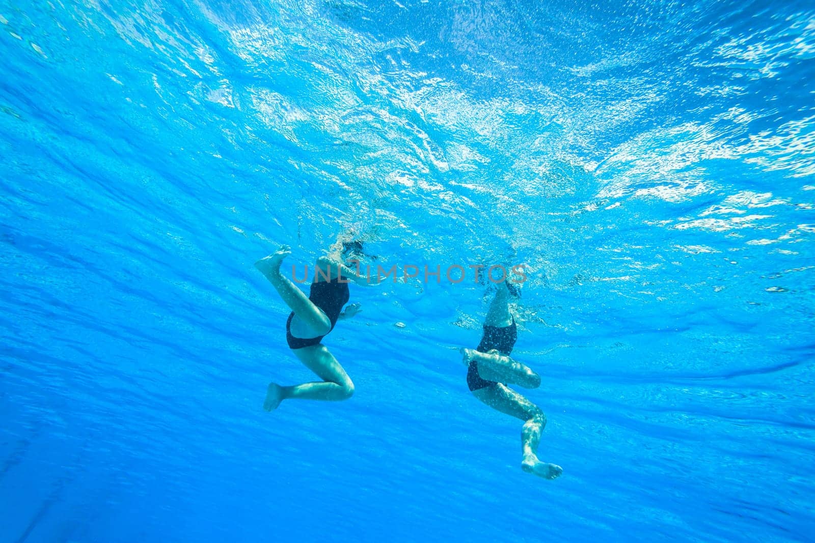 Girls Synchronized underwater swimming water action at national championships