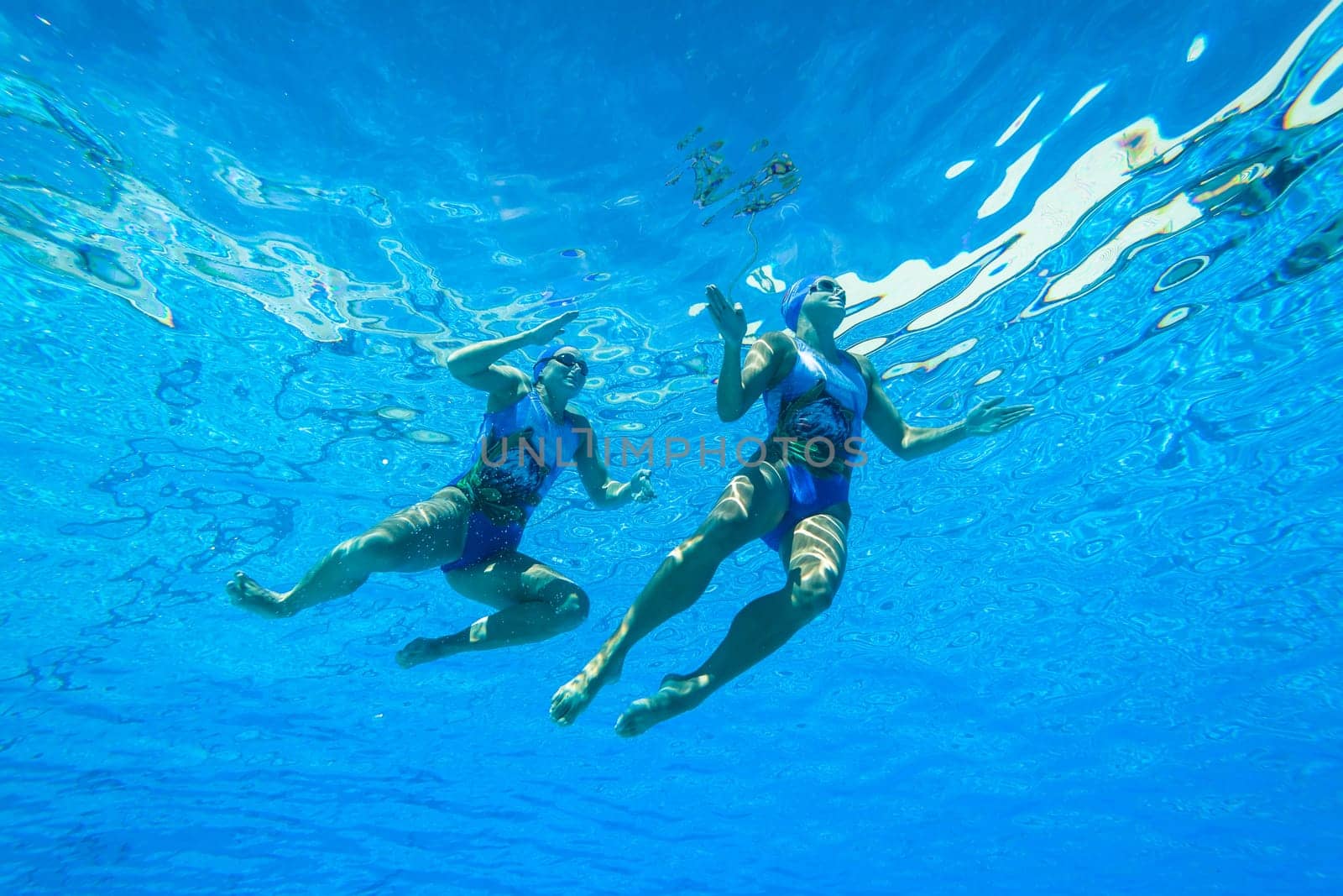 Girls Synchronized underwater swimming water action at national championships