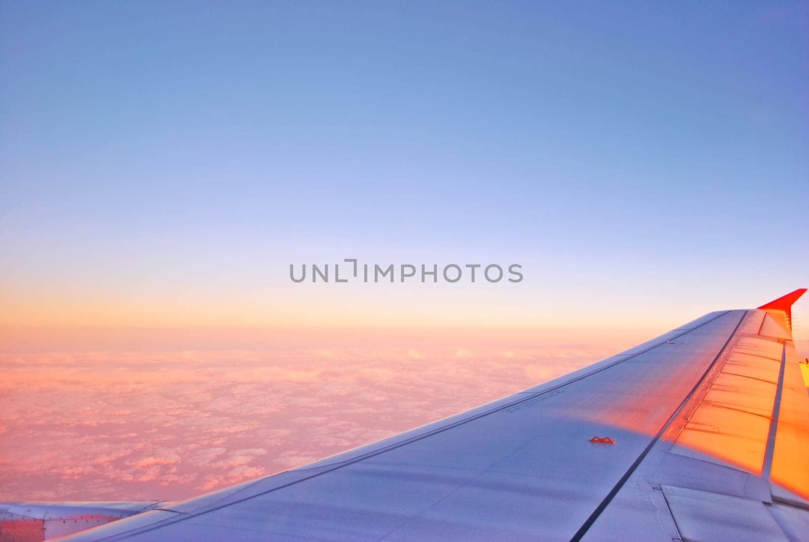 Airplane Flying above the Clouds