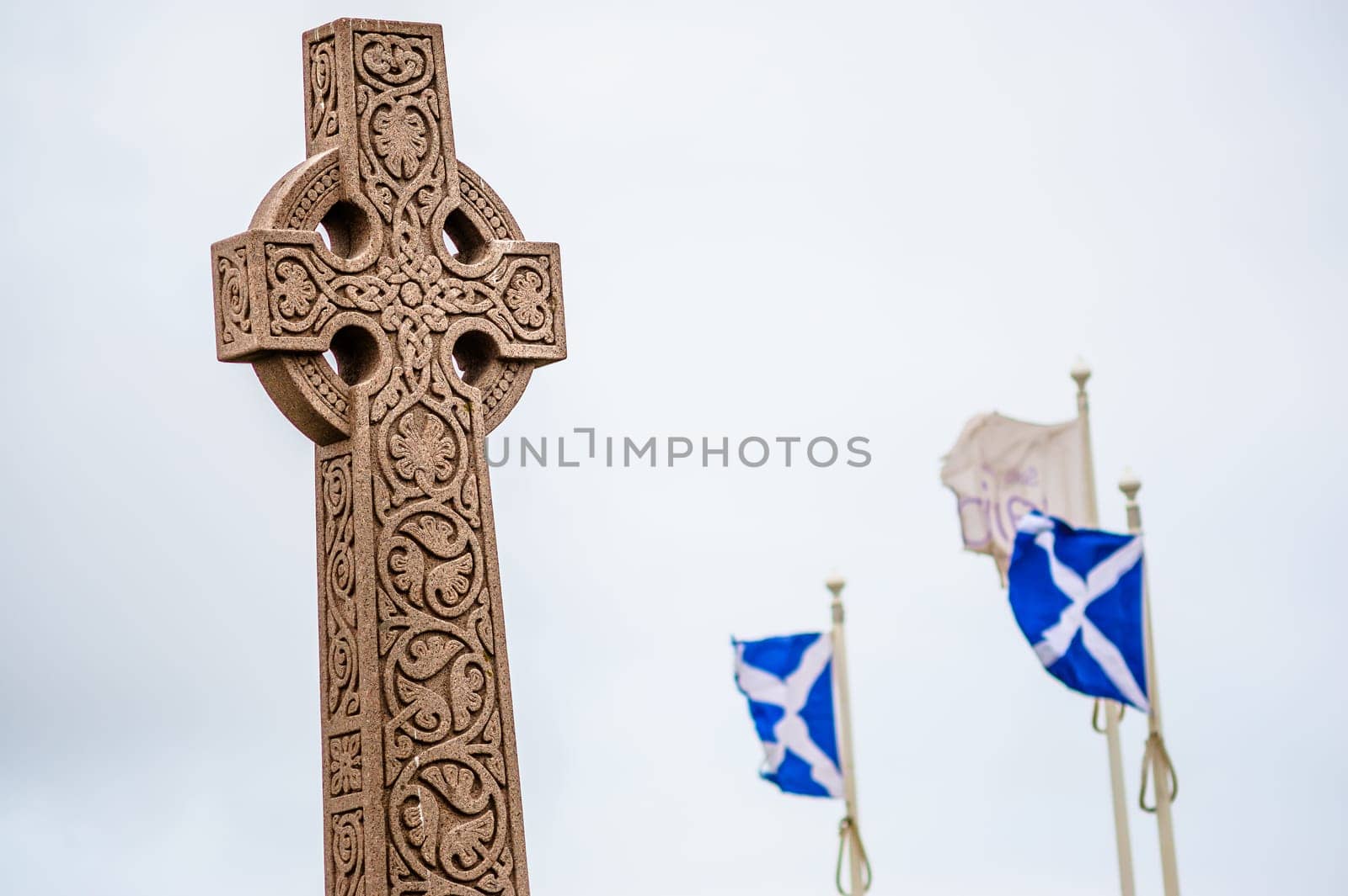 Old style celtic cross with visible national flags of Scotland - St Andrew's Cross Saltire.