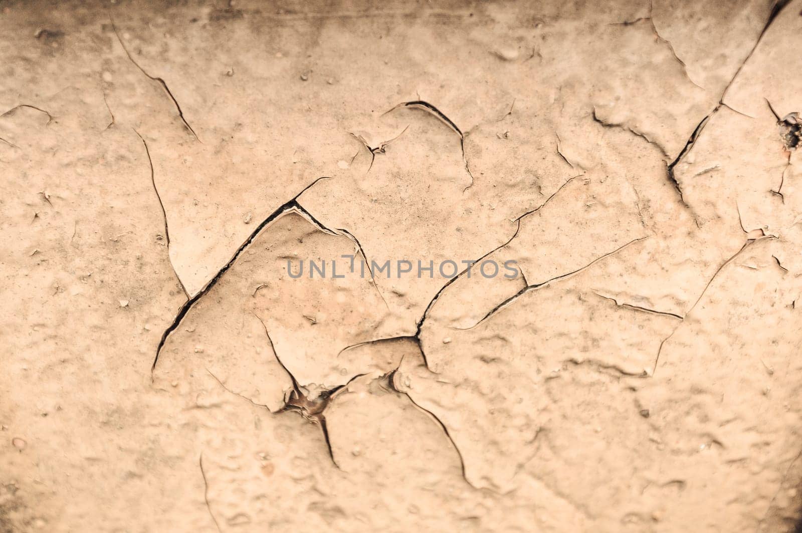 Piece of metal sheet covered with cracked paint.