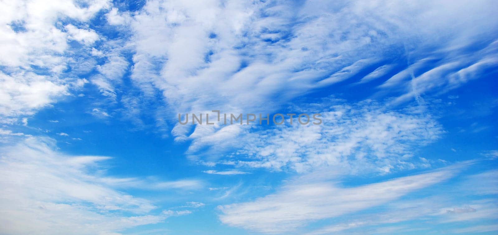 Blue sky background with a tiny clouds