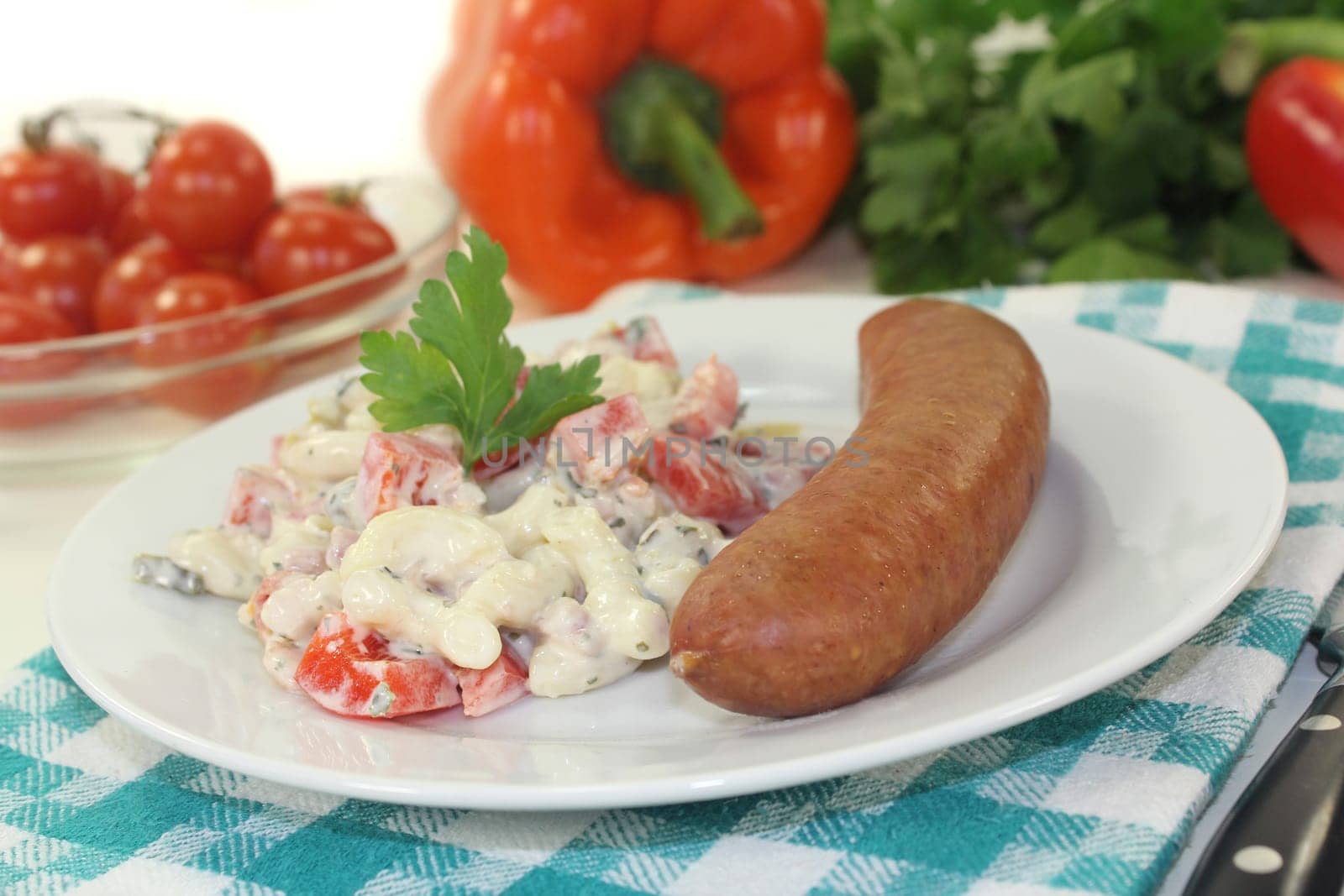 Mettenden with pasta salad against a white background