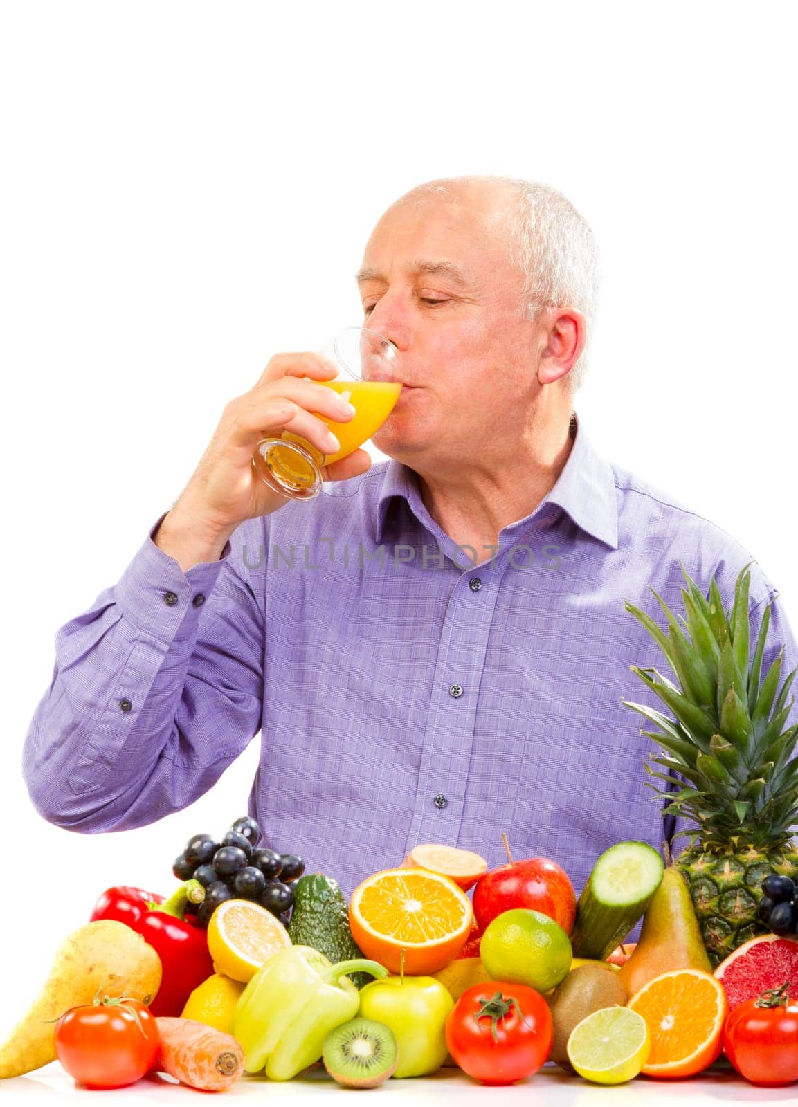 Mature man juice and standing next to fruits and vegetables isolated on white