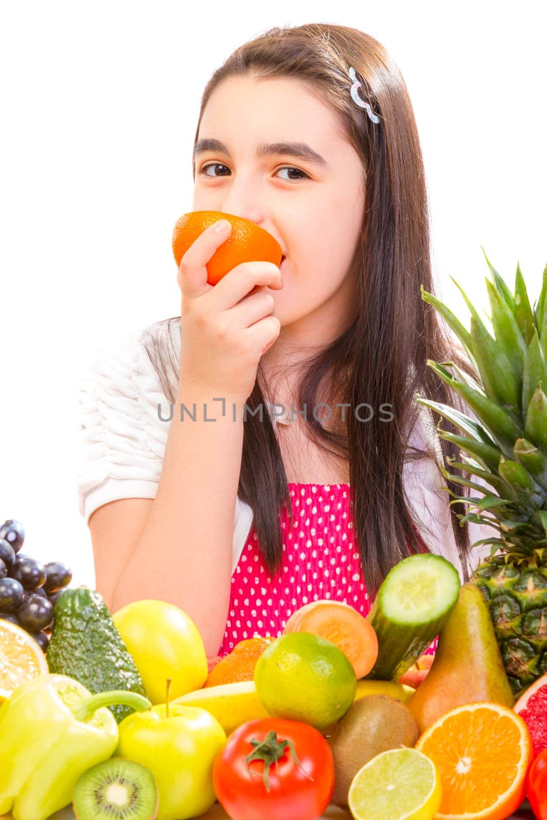 Little girl with fruits - Happy girl with fruits assortment on the table.
