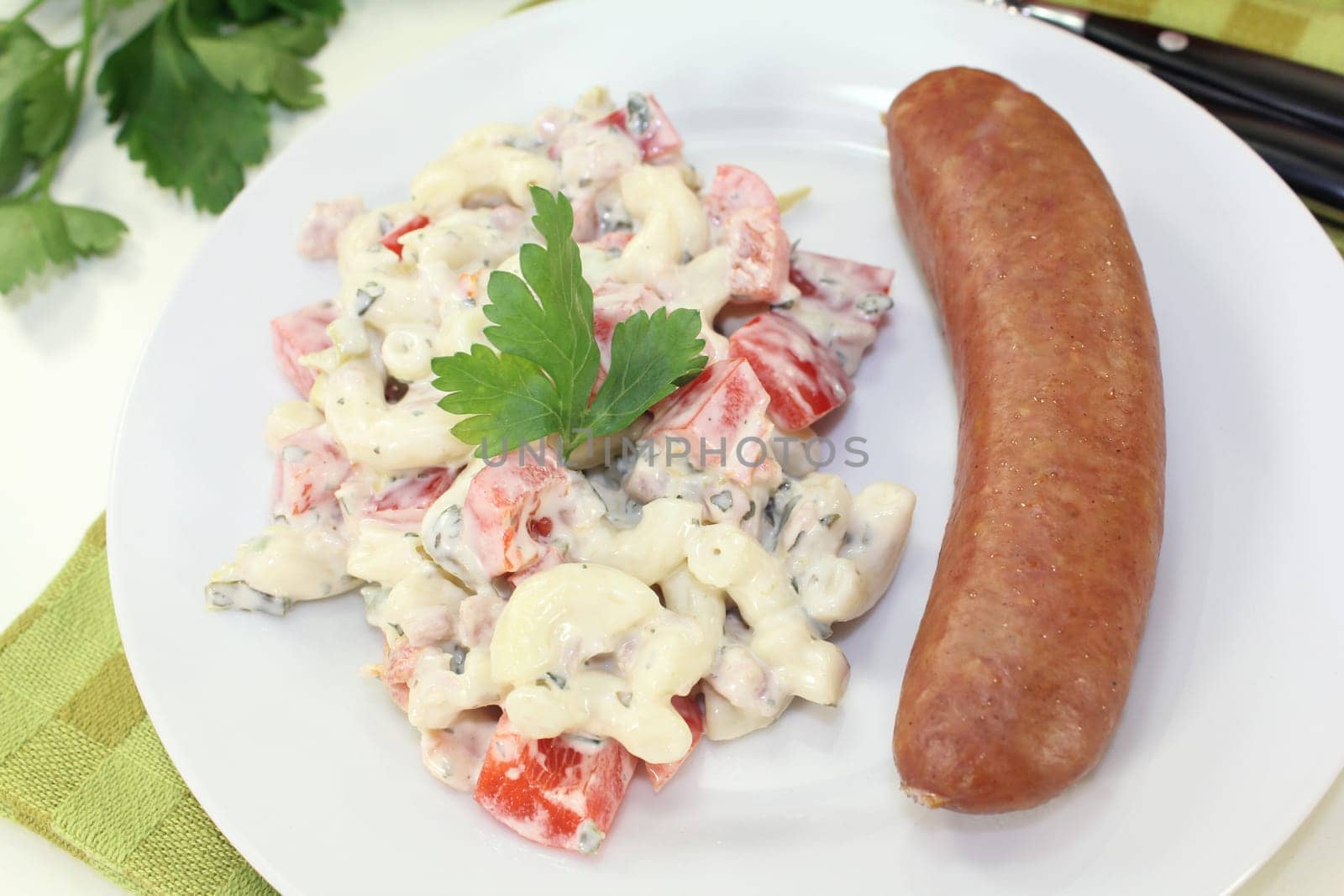Mettenden with pasta salad against a white background