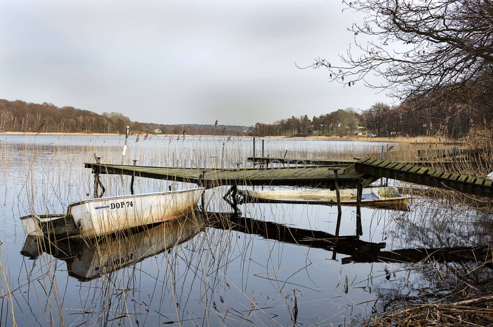 old dilapidated bridge with two old boats