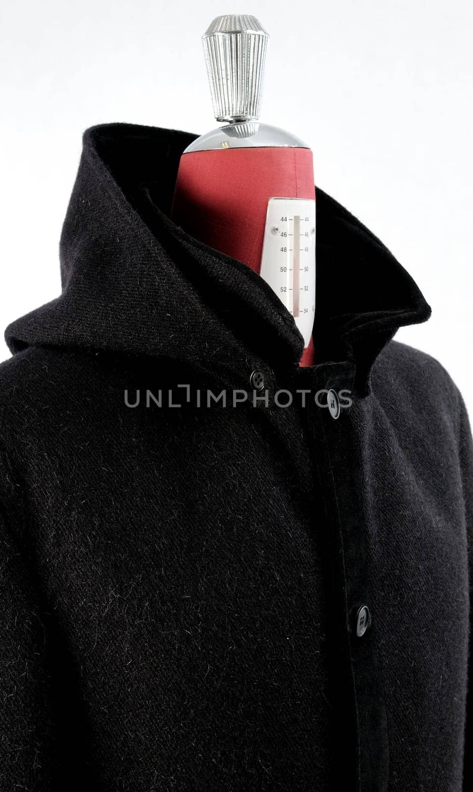 Woolen black coat, inserts and lining in velvet. Detachable hood.