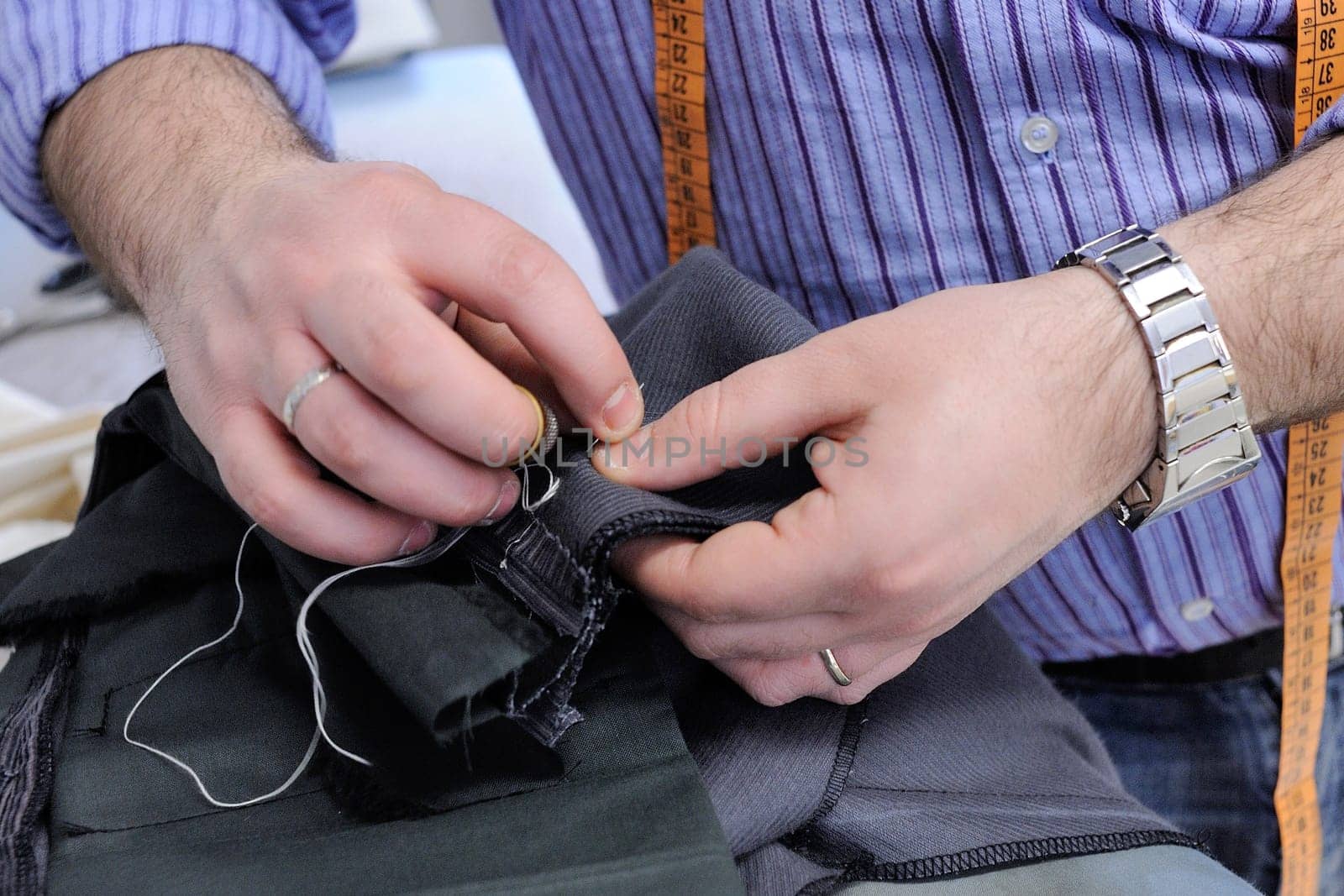 Handwork of bespoke suit, made by traditional tailoring of Sardinia.