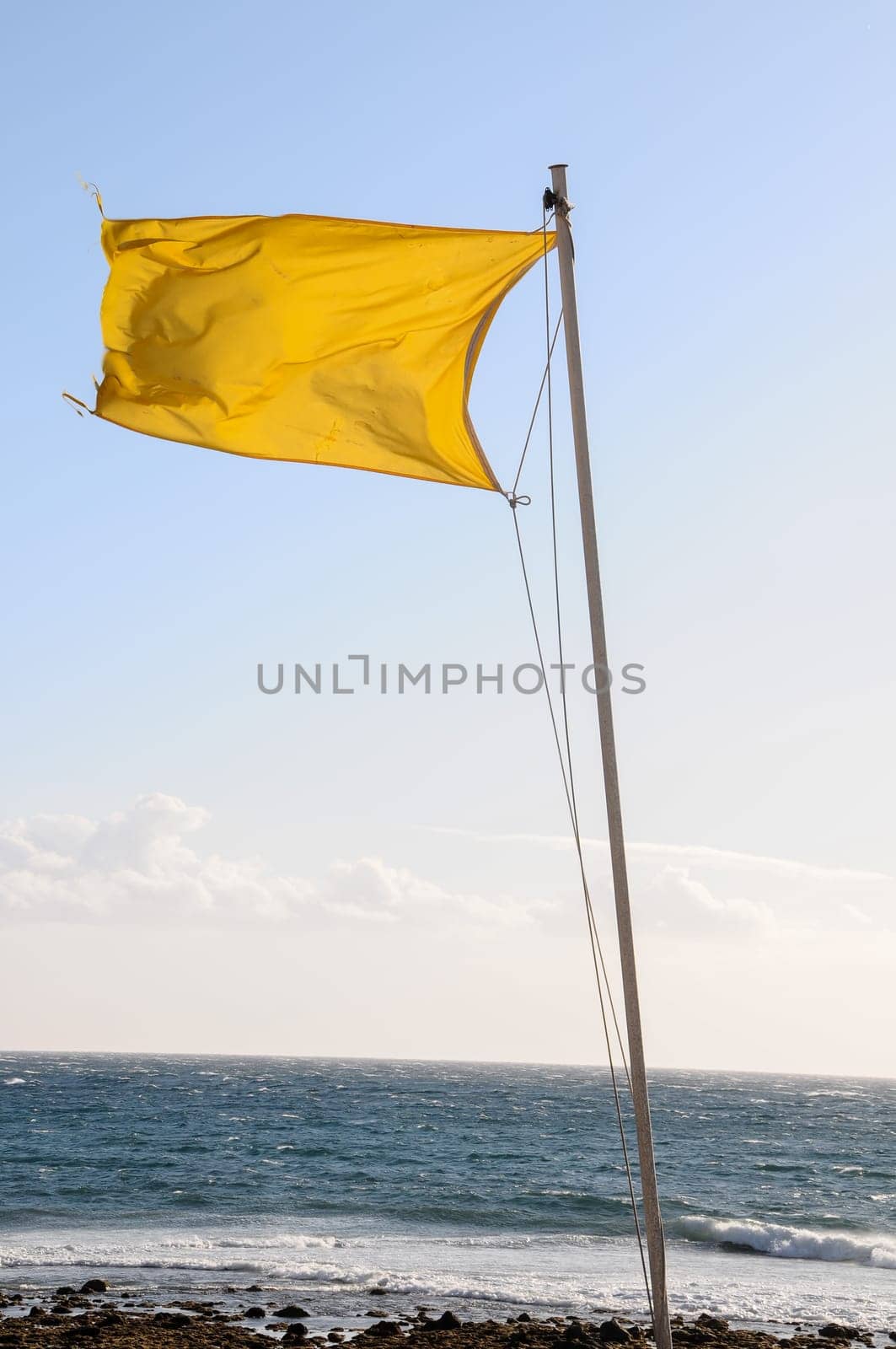 Yellow Festive Flag Waving In The Wind Tenerife Canry Island Spain