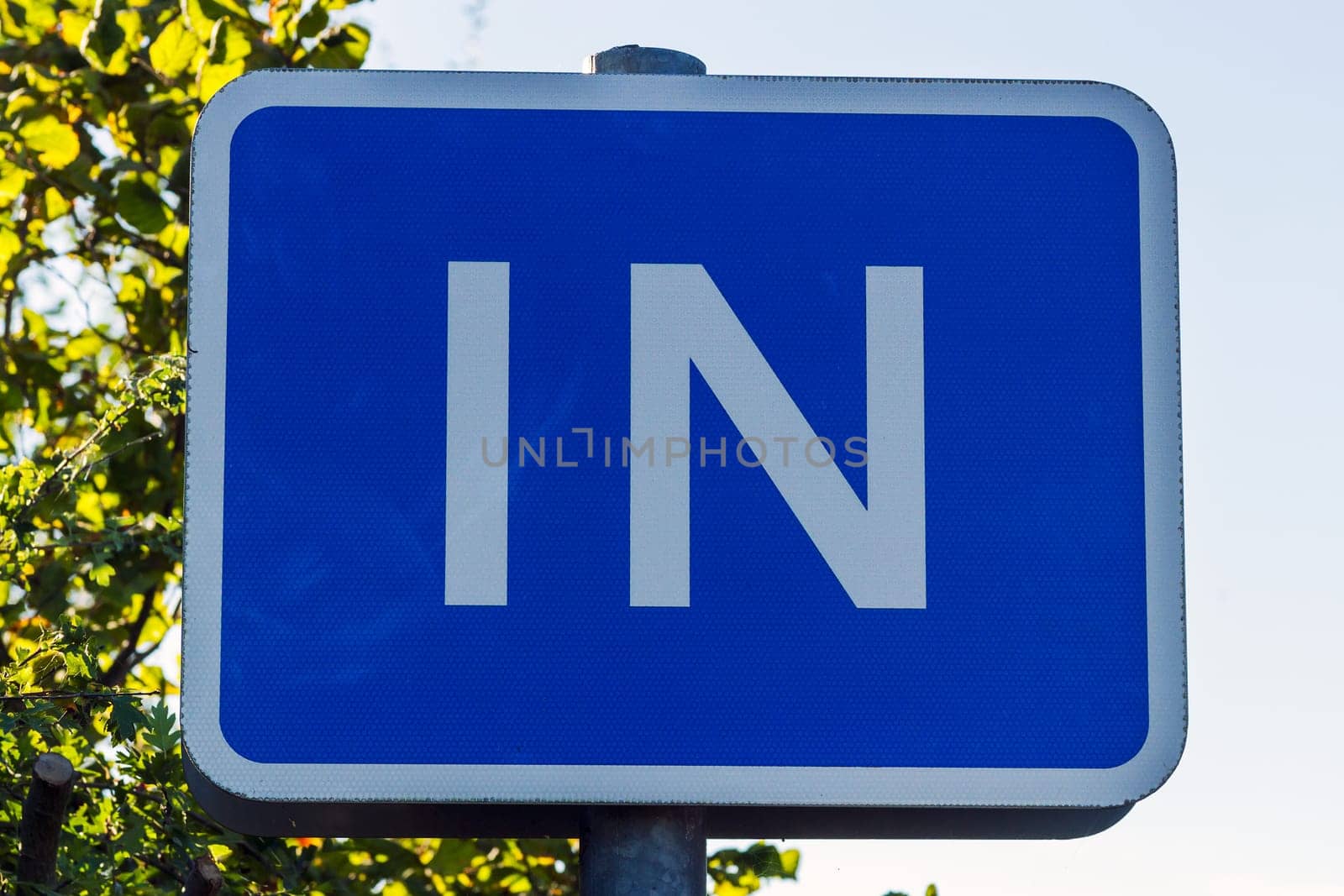 Blue sign indicating an entrance to traffic
