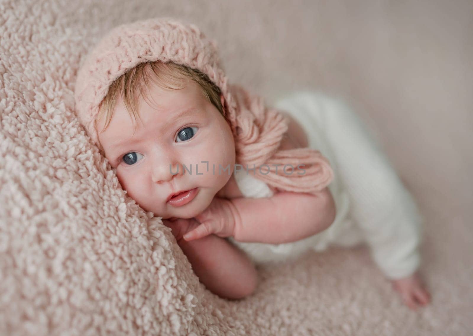 Sleeping newborn baby girl in knitted suit