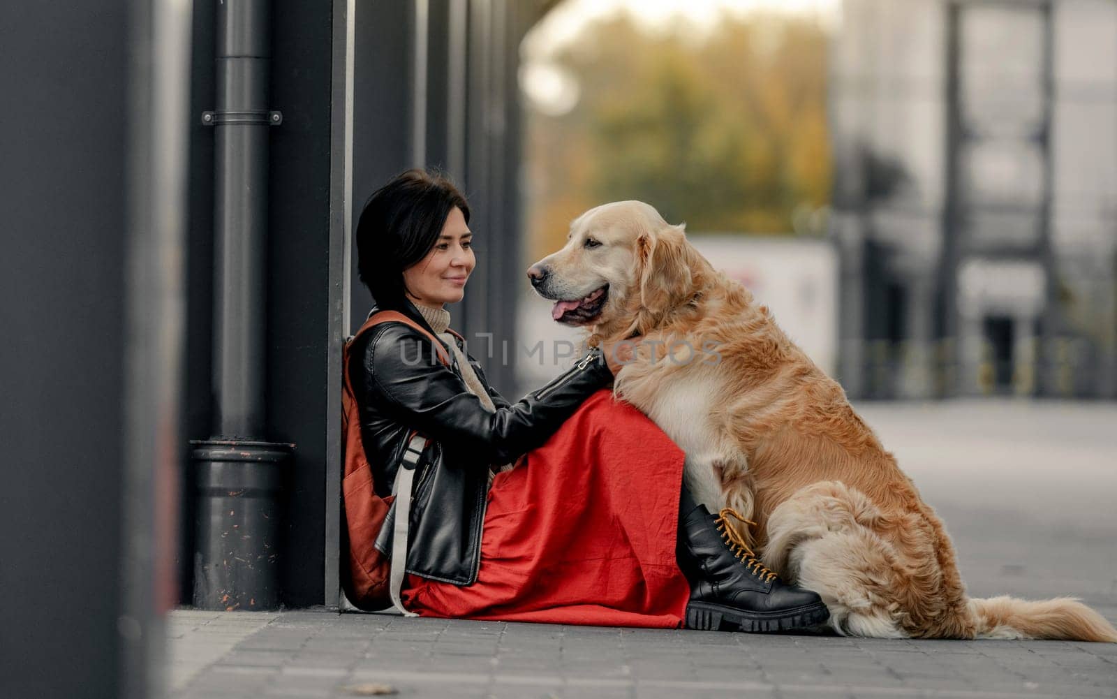 Young woman sitting outdoors with her dog by tan4ikk1