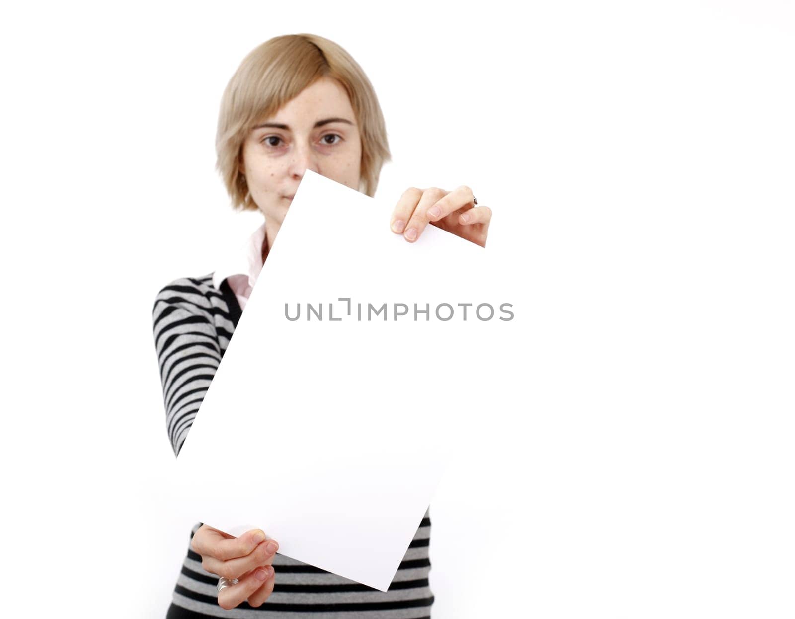 Young blonde woman holding a blank piece of paper.
