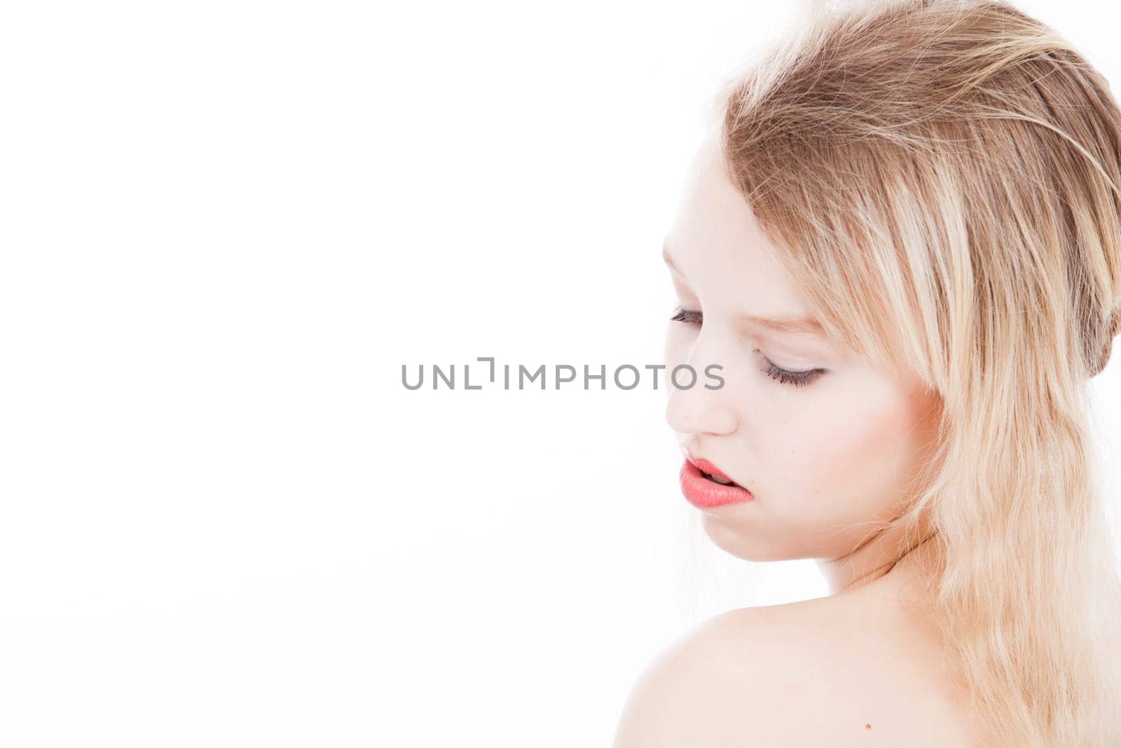 Portrait from young blond woman on a white background with much skin visible