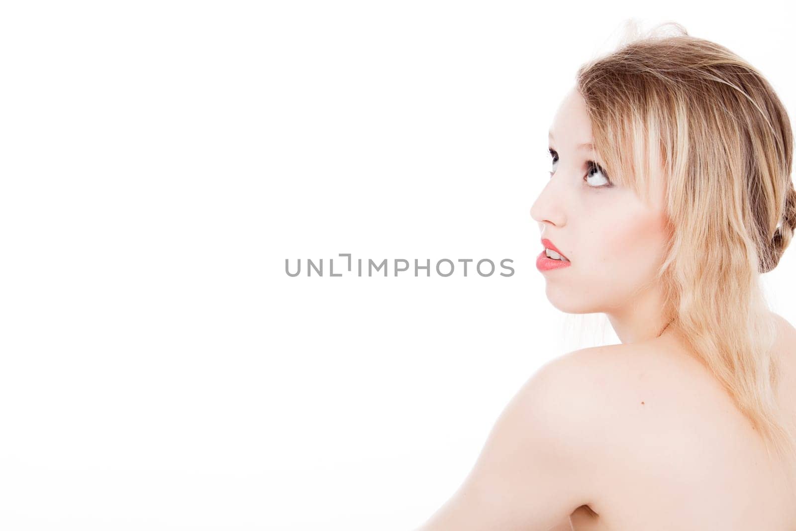 Portrait from young blond woman on a white background with much skin visible