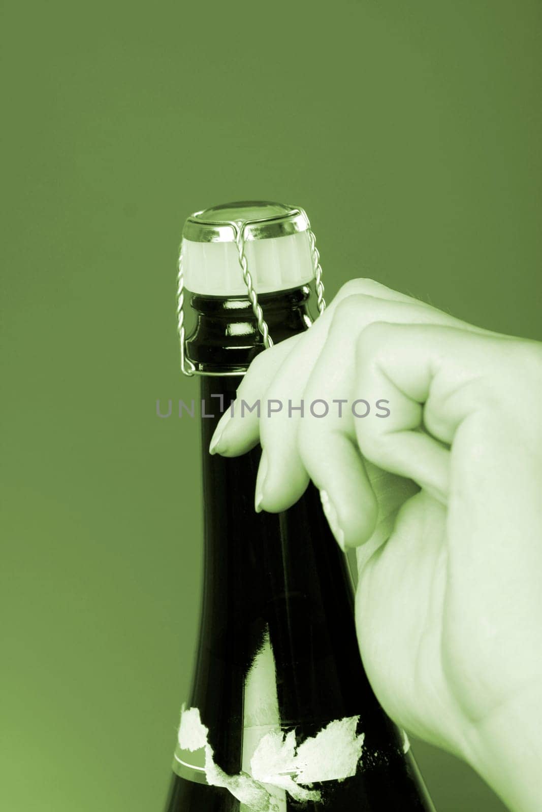 Woman hands opening champagne bottle