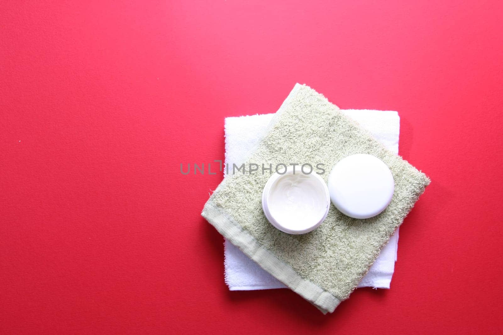 Moisturizing cream isolated on red