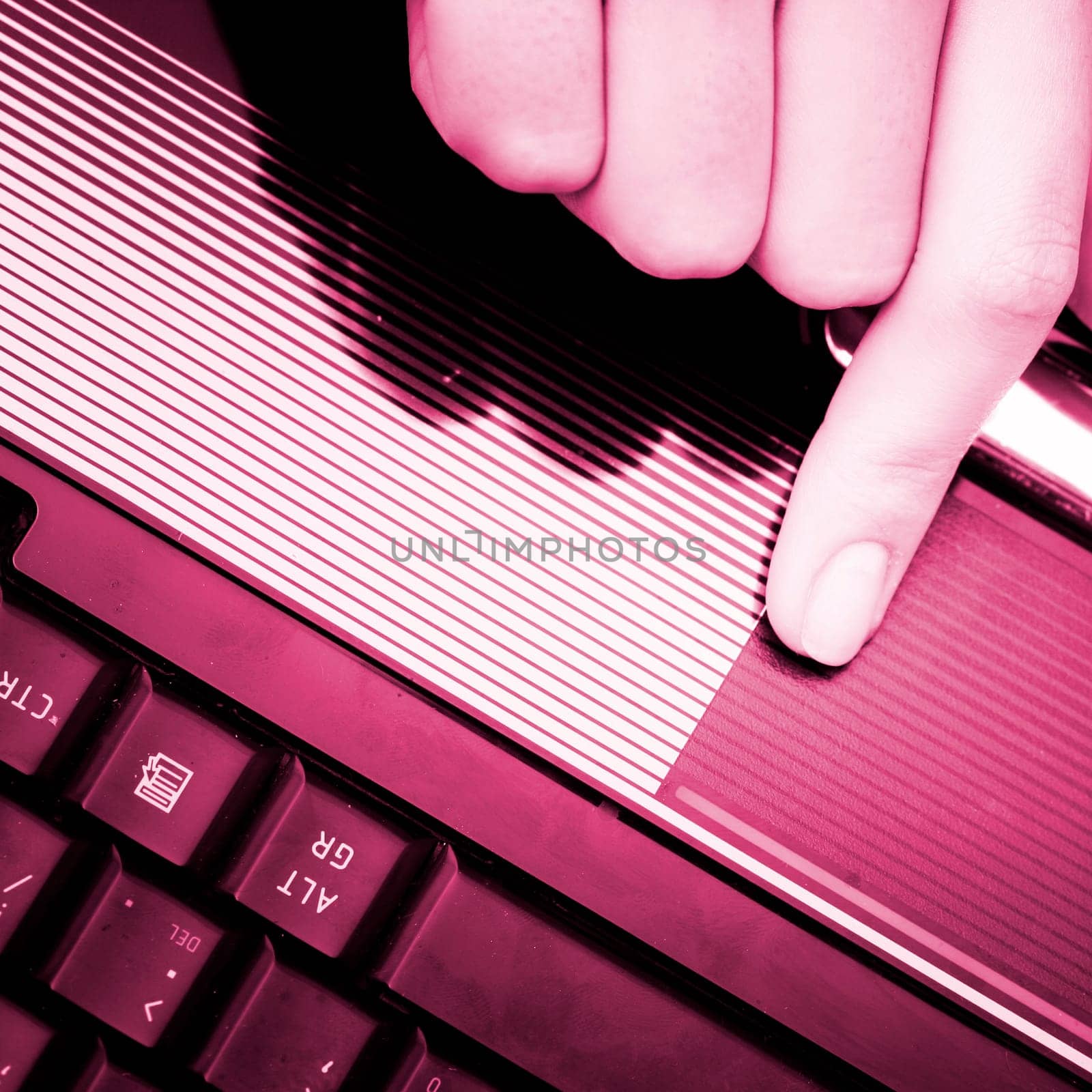 Closeup of woman's hand working at laptop.